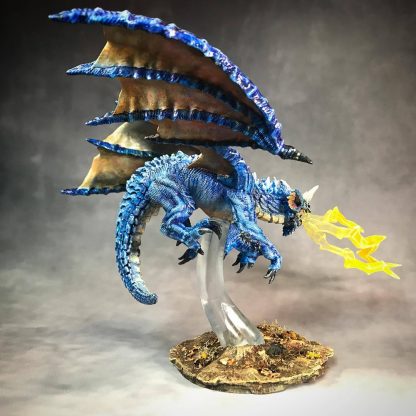 Hand-painted blue dragon fledgling miniature in flight with lightning shooting from its open maw resting on a clear plastic support post on a round base that looks like hardened earth